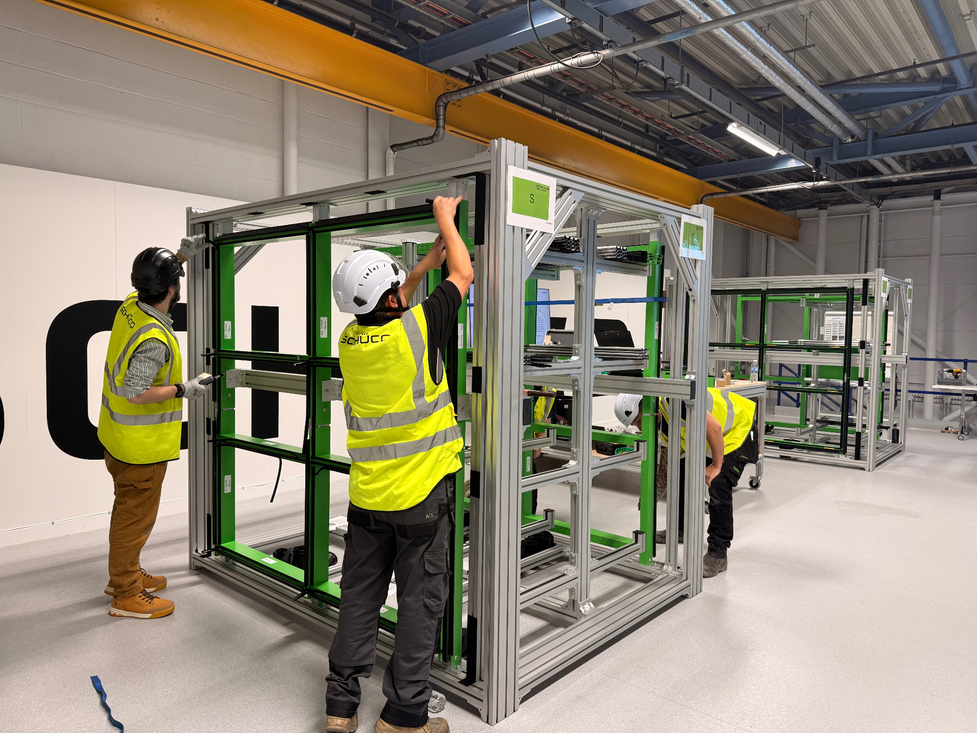 Delta Facades team assembling a full-scale Schüco FWS 50 curtain wall frame on the Academy training rig